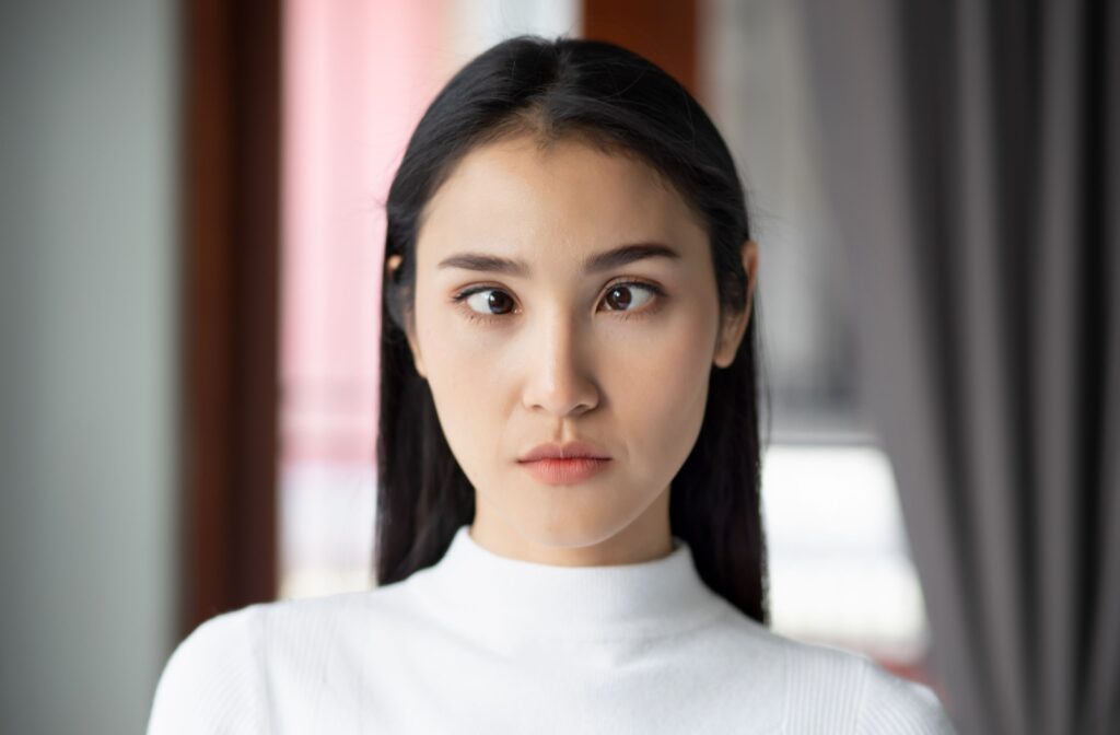 A young woman stares at the camera with a lazy eye.