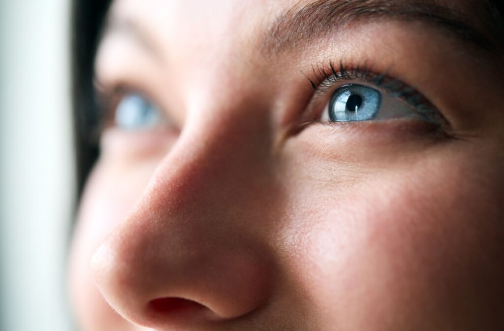 A close up of a person's eyes looking up, representing what eyes can tell about someone's health.
