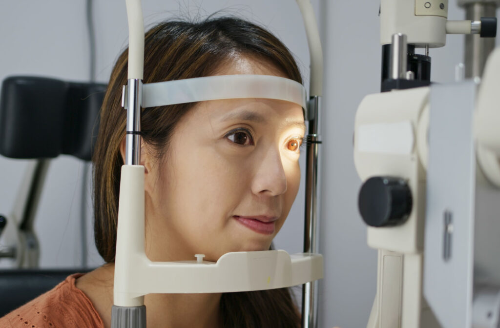 A person at an eye exam having the health of their eyes assessed.